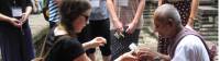 Girl receiving blessing from local monk at Angkor Wat