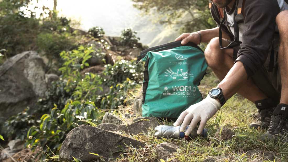 Traveller collecting litter along wilderness trails, part of our 10 Pieces litter collection program | Mark Tipple