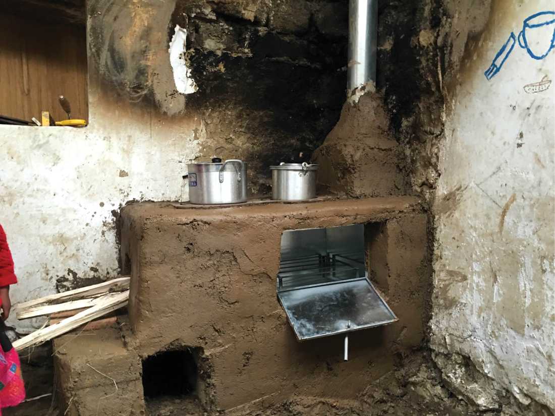Part way through installing a new cook stove in a kitchen in Huilloc village, Peru |  Dnona Lawrence