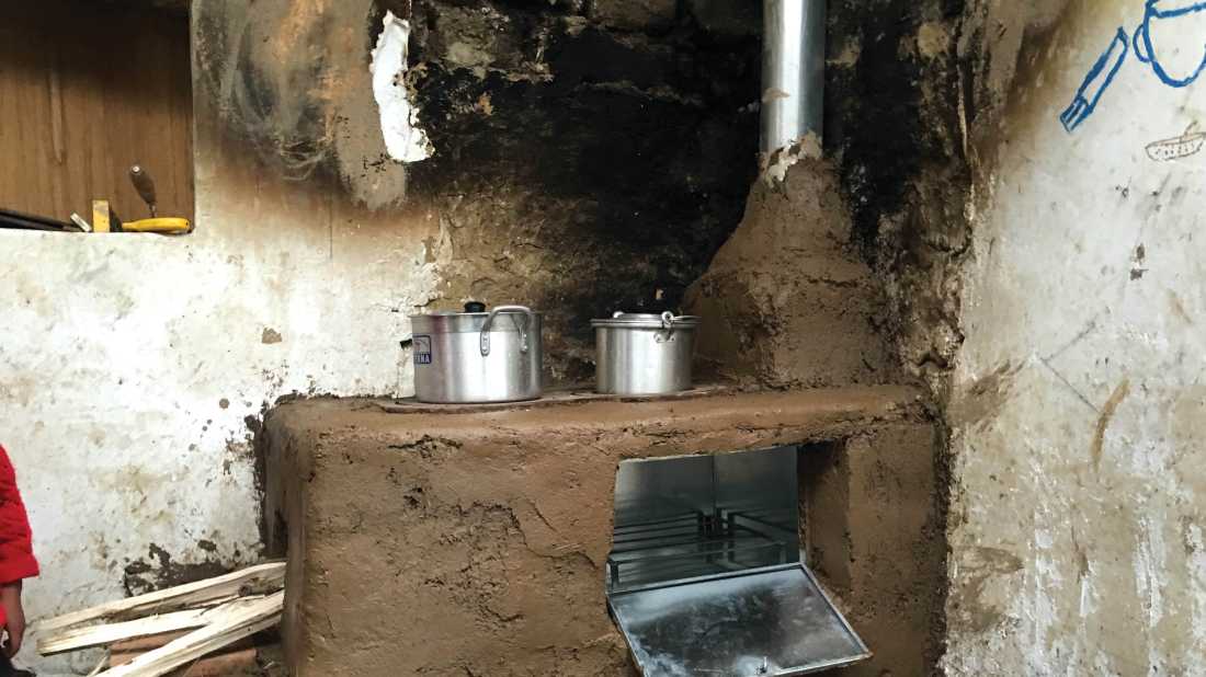 Part way through installing a new cook stove in a kitchen in Huilloc village, Peru |  Dnona Lawrence